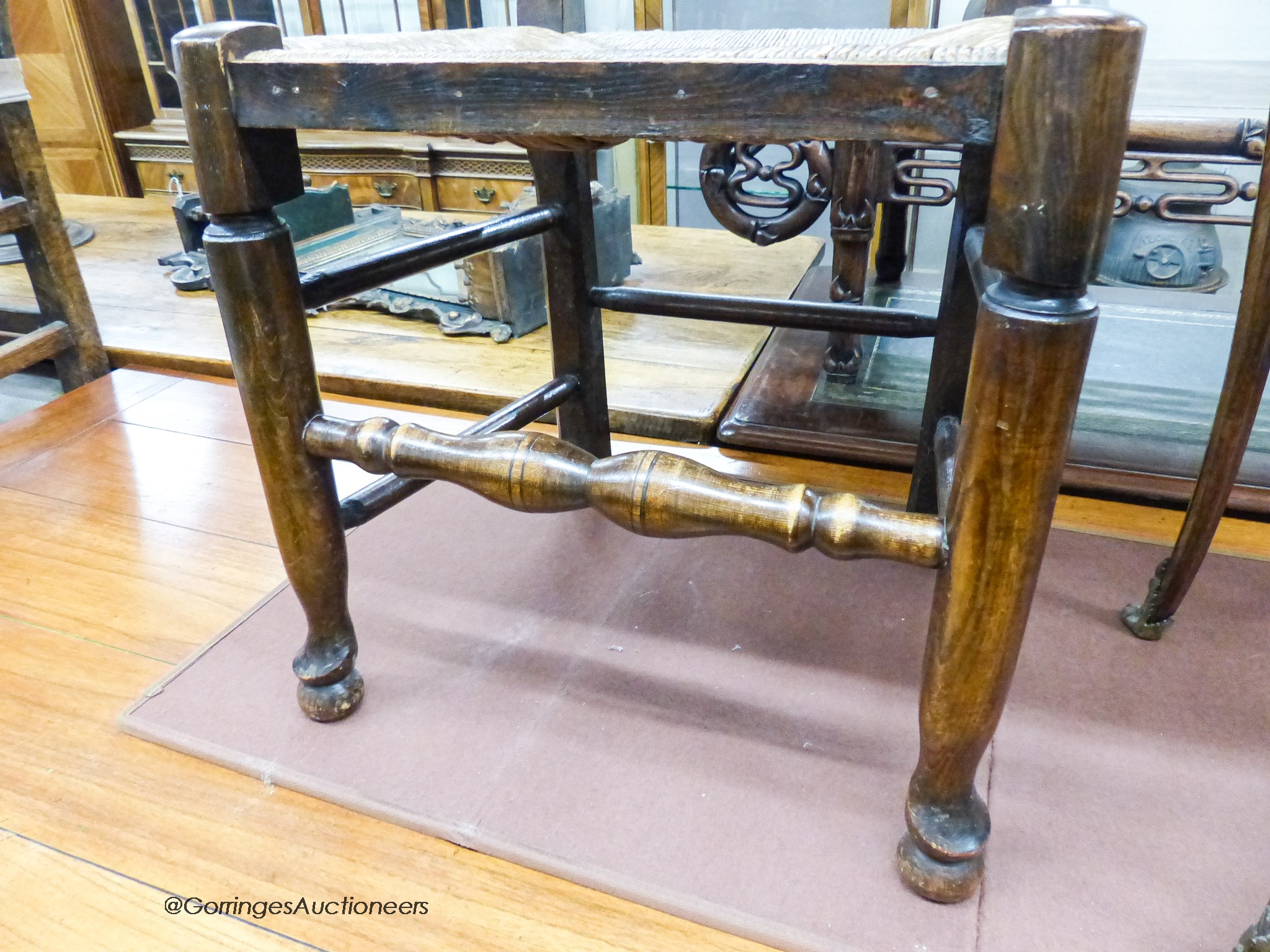 A set of four 18th century style ash rush seat ladderback dining chairs